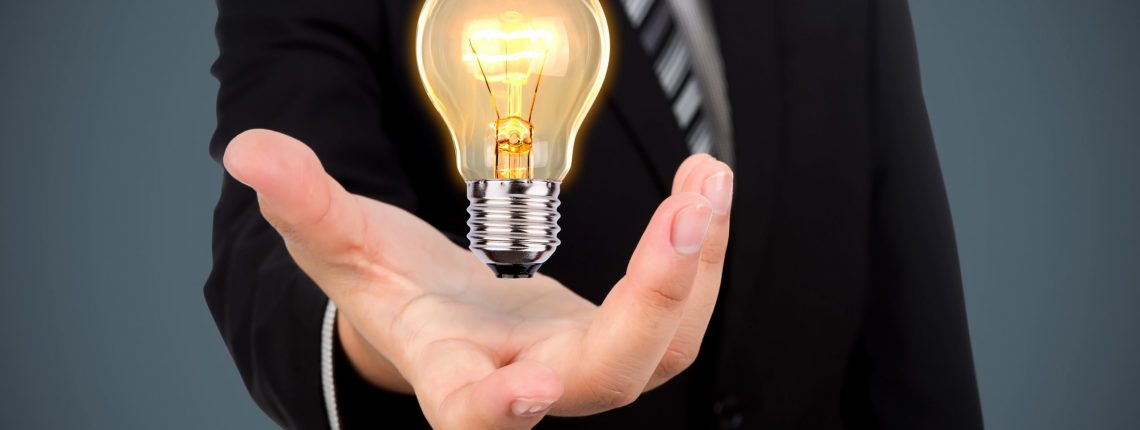 Business man holding light bulb